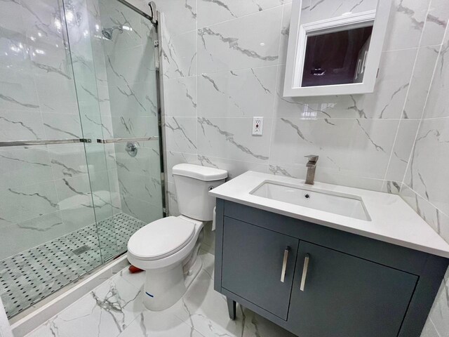 132-06 57th Rd, Flushing, NY 11355 - bathroom featuring tile walls, vanity, a marble finish shower, marble finish floors, and toilet