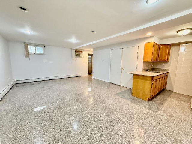 132-06 57th Rd, Flushing, NY 11355 - kitchen featuring brown cabinetry, light countertops, a wall mounted AC, a sink, and baseboard heating