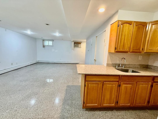 132-06 57th Rd, Flushing, NY 11355 - kitchen featuring a sink, granite floors, baseboards, brown cabinets, and a wall mounted AC