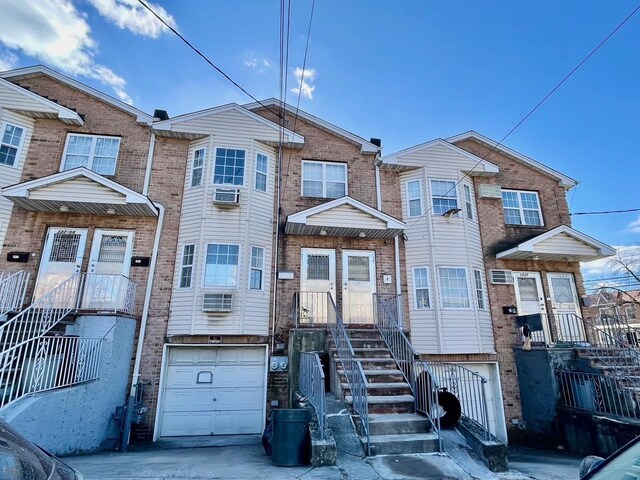 132-06 57th Rd, Flushing, NY 11355 - multi unit property featuring a garage, brick siding, and driveway