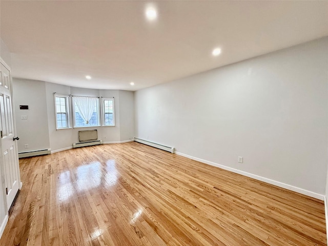 132-06 57th Rd, Flushing, NY 11355 - empty room featuring baseboard heating, light wood-style floors, recessed lighting, and baseboards