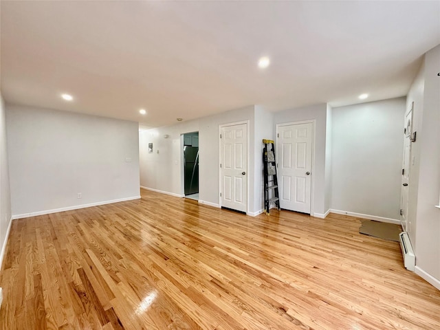 132-06 57th Rd, Flushing, NY 11355 - spare room featuring a baseboard heating unit, light wood finished floors, recessed lighting, and baseboards