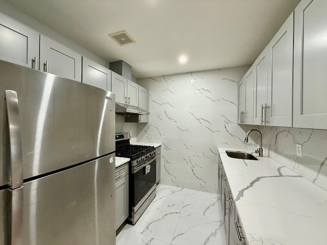 132-06 57th Rd, Flushing, NY 11355 - kitchen featuring appliances with stainless steel finishes, light marble finish floors, under cabinet range hood, light stone countertops, and tasteful backsplash