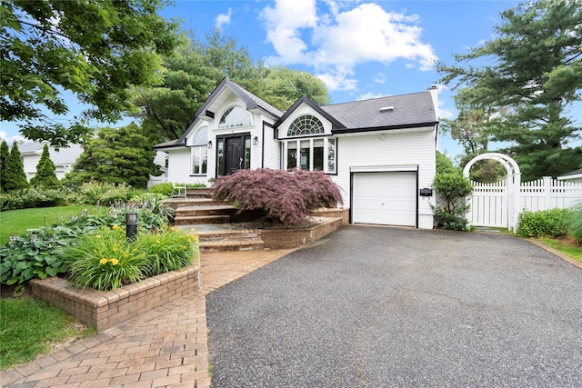 8 Ellis Dr, Syosset, NY 11791 - view of front of house with driveway, a garage, and roof with shingles
