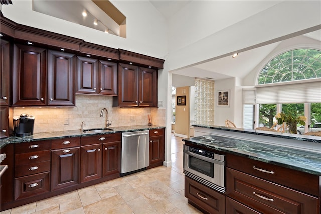 8 Ellis Dr, Syosset, NY 11791 - kitchen with stainless steel appliances, vaulted ceiling, decorative backsplash, and dark stone counters