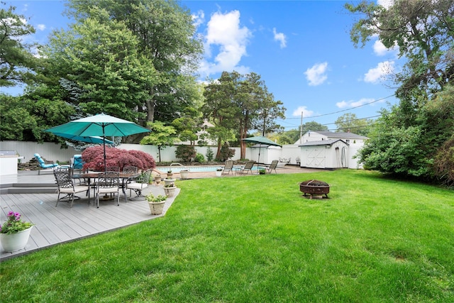 8 Ellis Dr, Syosset, NY 11791 - fenced backyard featuring an outdoor fire pit, a deck, outdoor dining area, and a shed