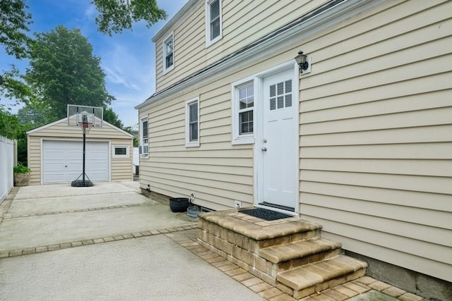 532 7th St, West Hempstead, NY 11552 - view of exterior entry with a garage and driveway