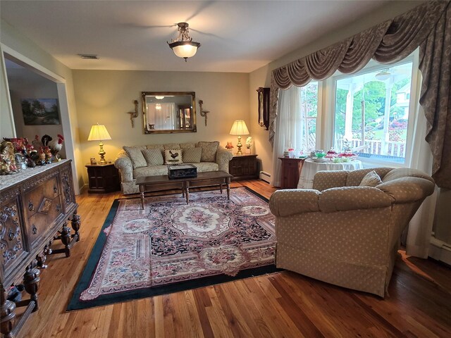 18 Laura Ct, Nesconset, NY 11767 - living room featuring wood finished floors and baseboard heating