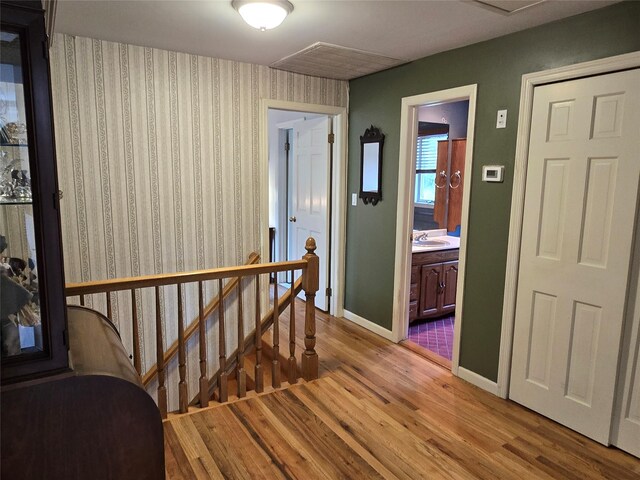 18 Laura Ct, Nesconset, NY 11767 - corridor featuring light wood-style flooring and an upstairs landing