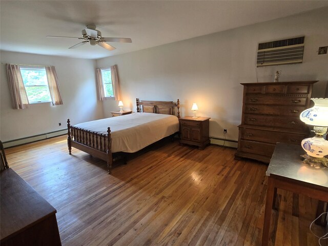 18 Laura Ct, Nesconset, NY 11767 - bedroom featuring a baseboard radiator, dark wood-type flooring, and a wall unit AC
