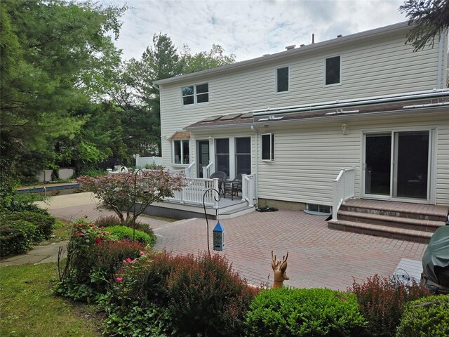 18 Laura Ct, Nesconset, NY 11767 - back of property featuring a patio area, a wooden deck, and entry steps