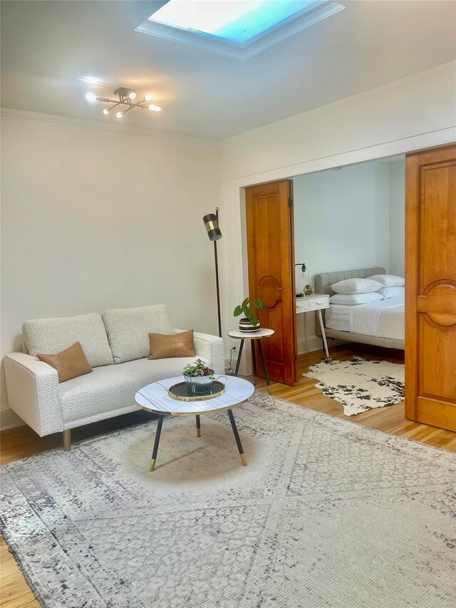 100-15 Ascan Ave, Forest Hills, NY 11375 - living room featuring a skylight, light wood-type flooring, and ornamental molding