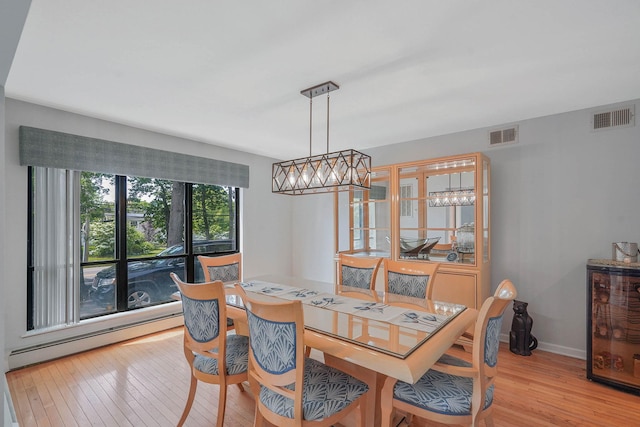 318 Sheep Pasture Rd, East Setauket, NY 11733 - dining space featuring light wood-style floors, a baseboard heating unit, and baseboards