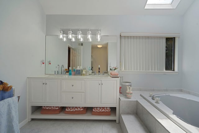 318 Sheep Pasture Rd, East Setauket, NY 11733 - bathroom with a skylight, double vanity, a bath, and tile patterned flooring
