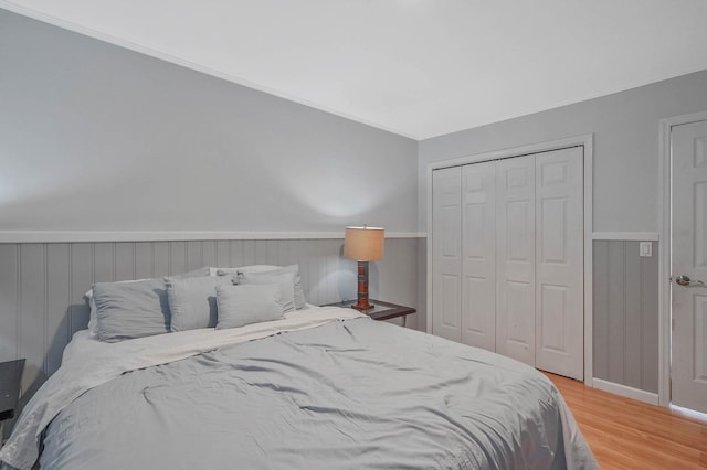 318 Sheep Pasture Rd, East Setauket, NY 11733 - bedroom featuring wood finished floors, a closet, and wainscoting