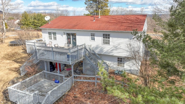 7 Tufts Ln, Highland Mills, NY 10930 - rear view of house featuring stairway, a deck, a shingled roof, and a trampoline