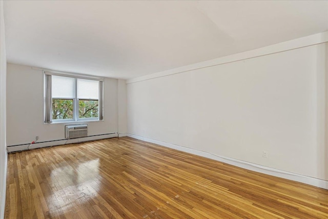 54-44 Little Neck Pkwy Unit 5G, Little Neck, NY 11362 - empty room with a baseboard radiator, hardwood / wood-style floors, and a wall mounted AC