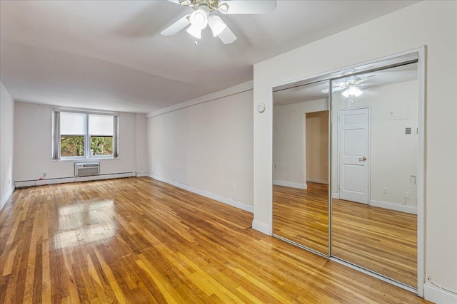 54-44 Little Neck Pkwy Unit 5G, Little Neck, NY 11362 - unfurnished bedroom with light wood-style floors, a baseboard radiator, a closet, and ceiling fan