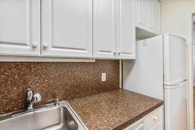 54-44 Little Neck Pkwy Unit 5G, Little Neck, NY 11362 - kitchen featuring freestanding refrigerator, white cabinetry, dark countertops, and backsplash