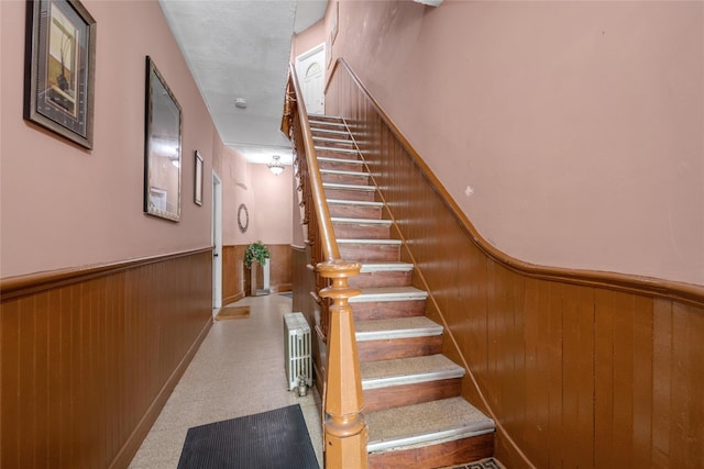 5-17 51st Ave, Long Island City, NY 11101 - staircase with a wainscoted wall, radiator, wood walls, and tile patterned floors