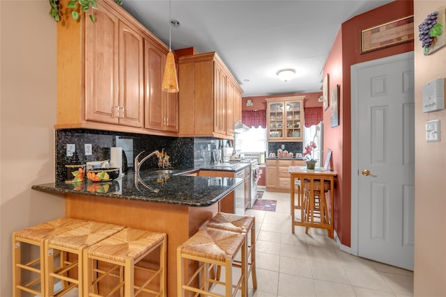 5-17 51st Ave, Long Island City, NY 11101 - kitchen featuring a sink, backsplash, a peninsula, a breakfast bar area, and light tile patterned flooring