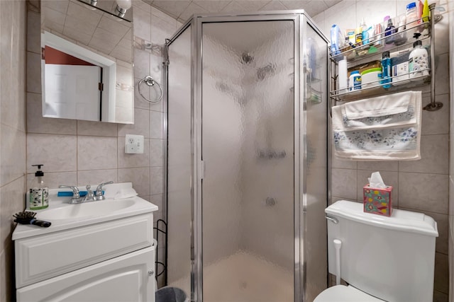 5-17 51st Ave, Long Island City, NY 11101 - full bathroom featuring tile walls, vanity, toilet, a shower stall, and tasteful backsplash