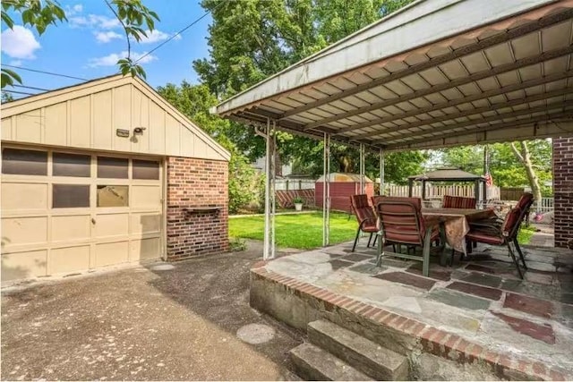 49-75 175th Pl, Fresh Meadows, NY 11365 - view of patio / terrace with an outdoor structure, a gazebo, driveway, a garage, and outdoor dining area