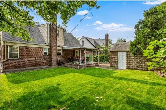 49-75 175th Pl, Fresh Meadows, NY 11365 - back of property with a patio, a yard, brick siding, and a chimney