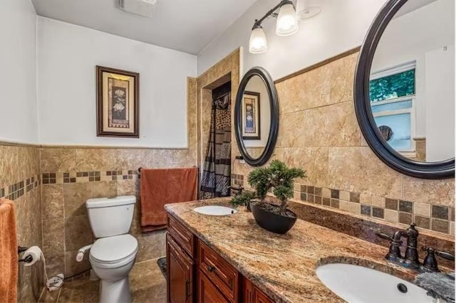 49-75 175th Pl, Fresh Meadows, NY 11365 - bathroom with toilet, tile walls, double vanity, and a wainscoted wall