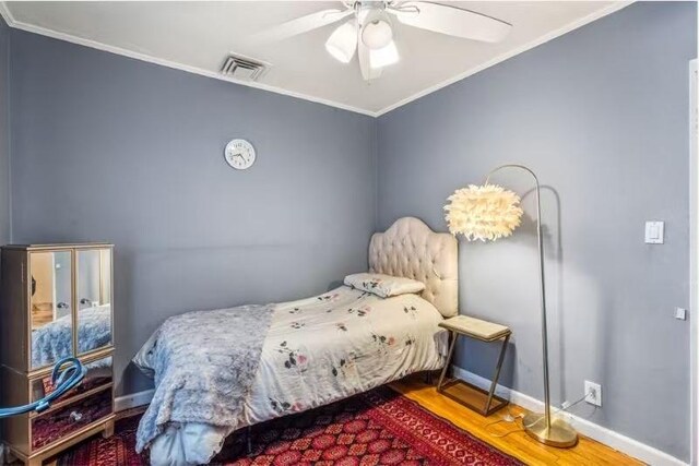 49-75 175th Pl, Fresh Meadows, NY 11365 - bedroom featuring ornamental molding, baseboards, wood finished floors, and ceiling fan
