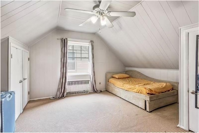 49-75 175th Pl, Fresh Meadows, NY 11365 - carpeted bedroom featuring radiator, vaulted ceiling, ceiling fan, and wood walls