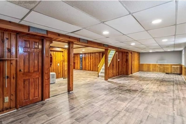 49-75 175th Pl, Fresh Meadows, NY 11365 - finished below grade area featuring wood walls, wood finished floors, stairway, a drop ceiling, and a wainscoted wall