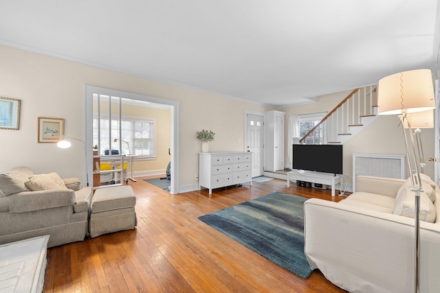 206 Brower Ave, Rockville Centre, NY 11570 - living area with stairs, healthy amount of natural light, and hardwood / wood-style floors
