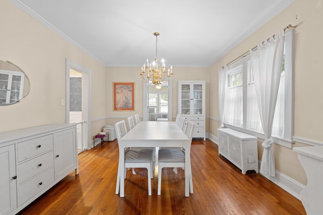 206 Brower Ave, Rockville Centre, NY 11570 - dining space with a chandelier, radiator heating unit, dark wood finished floors, and crown molding