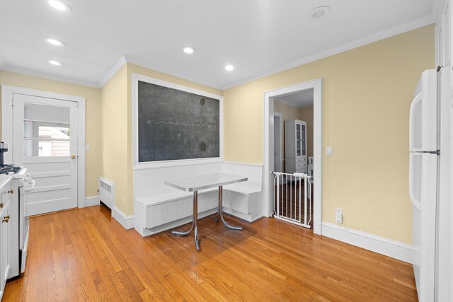 206 Brower Ave, Rockville Centre, NY 11570 - kitchen with white appliances, light wood finished floors, crown molding, recessed lighting, and light countertops