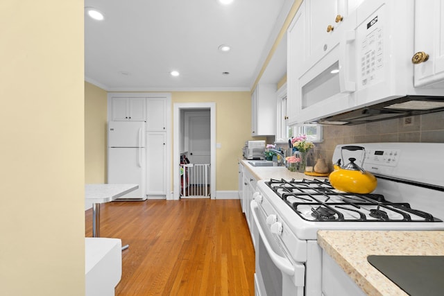 206 Brower Ave, Rockville Centre, NY 11570 - kitchen featuring white appliances, light countertops, white cabinets, decorative backsplash, and ornamental molding