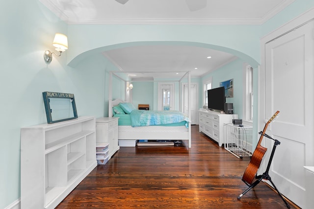 206 Brower Ave, Rockville Centre, NY 11570 - bedroom featuring arched walkways, dark wood-type flooring, and crown molding