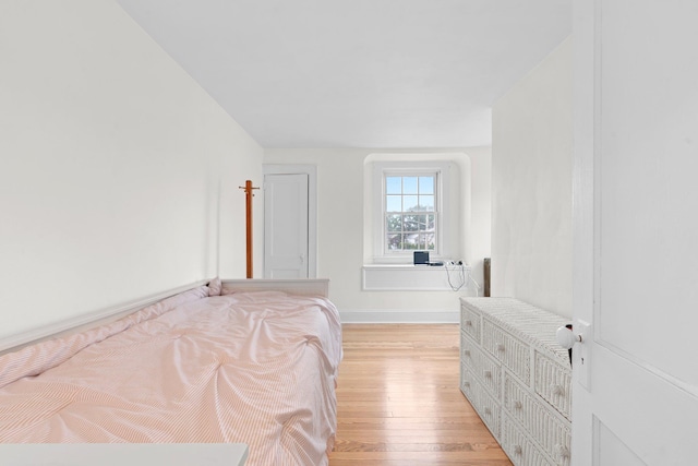 206 Brower Ave, Rockville Centre, NY 11570 - bedroom with light wood-style flooring and baseboards