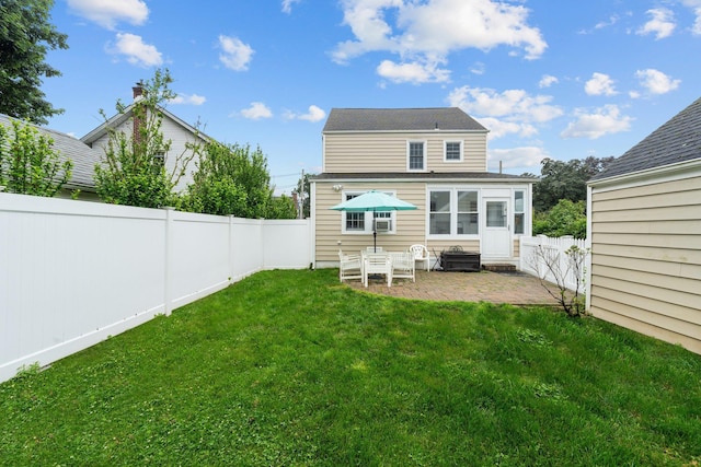 206 Brower Ave, Rockville Centre, NY 11570 - rear view of house with a patio area and a fenced backyard