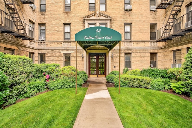 43 Calton Rd Unit 4J, New Rochelle, NY 10804 - entrance to property with brick siding, a yard, and french doors