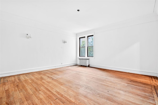 43 Calton Rd Unit 4J, New Rochelle, NY 10804 - unfurnished room with radiator, hardwood / wood-style floors, and baseboards