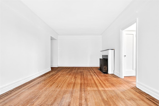 43 Calton Rd Unit 4J, New Rochelle, NY 10804 - unfurnished living room featuring light wood finished floors and a fireplace