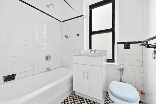 43 Calton Rd Unit 4J, New Rochelle, NY 10804 - bathroom with washtub / shower combination, vanity, tile walls, toilet, and wainscoting