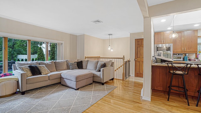 6 Sycamore Pl, Smithtown, NY 11787 - living area with light wood finished floors, recessed lighting, and ornamental molding