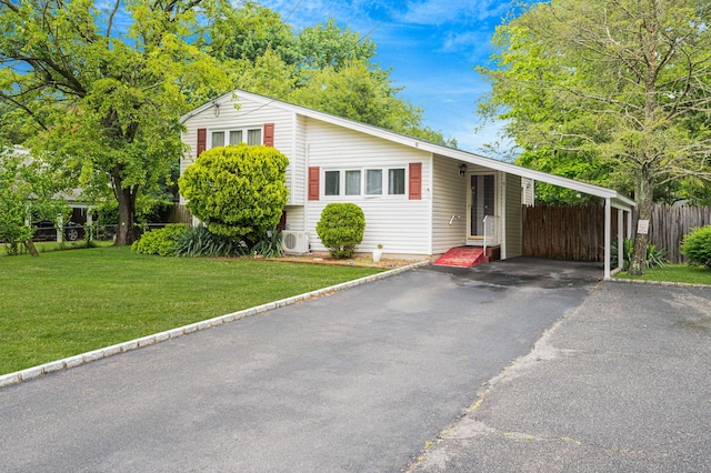9 Laurie Rd, Brentwood, NY 11717 - view of front facade featuring a carport and asphalt driveway