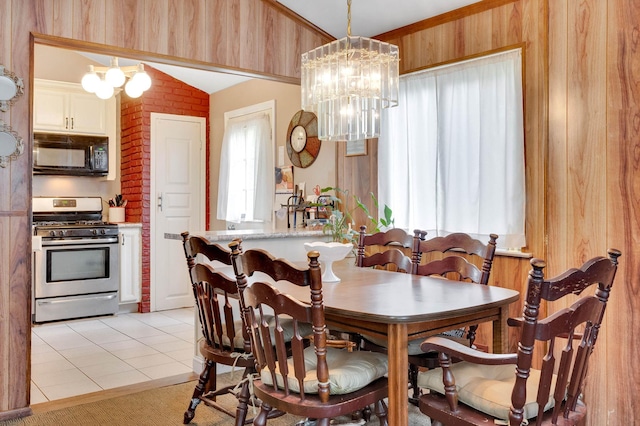 9 Laurie Rd, Brentwood, NY 11717 - dining space with vaulted ceiling, a chandelier, and wood walls