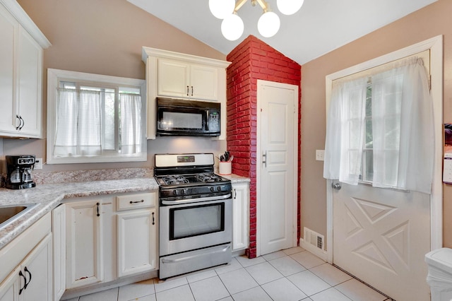 9 Laurie Rd, Brentwood, NY 11717 - kitchen featuring black microwave, gas stove, vaulted ceiling, light tile patterned floors, and a chandelier
