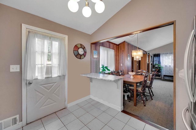 9 Laurie Rd, Brentwood, NY 11717 - dining room featuring a chandelier, lofted ceiling, and light tile patterned floors
