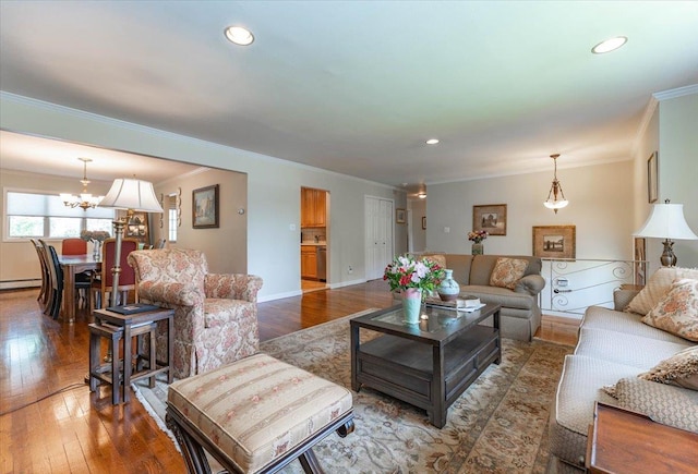 528 Longacre Ave, Woodmere, NY 11598 - living room featuring crown molding, wood-type flooring, baseboard heating, a chandelier, and recessed lighting