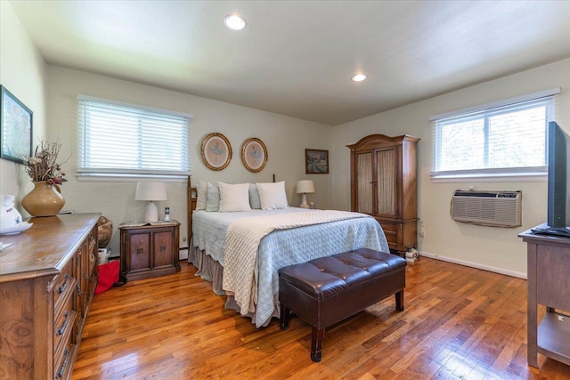 528 Longacre Ave, Woodmere, NY 11598 - bedroom with an AC wall unit, light wood finished floors, recessed lighting, baseboard heating, and baseboards